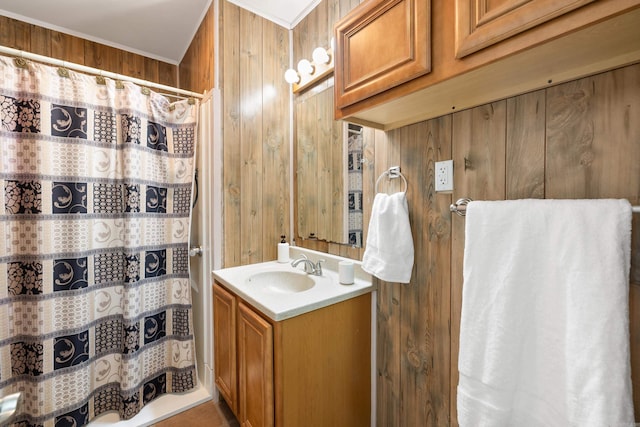 full bath featuring vanity, wood walls, and curtained shower