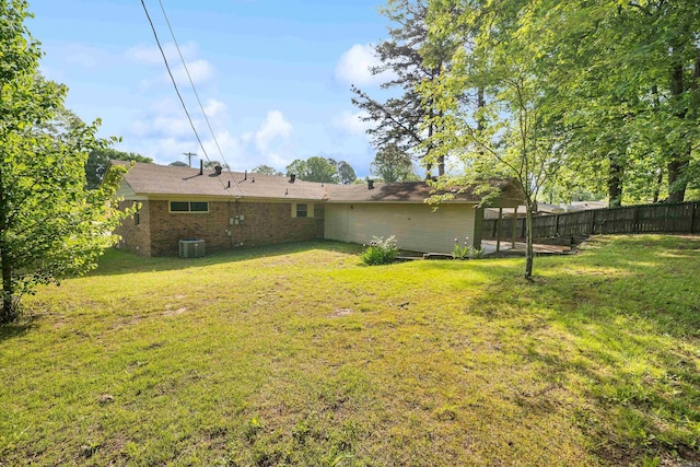 view of yard with fence and central AC