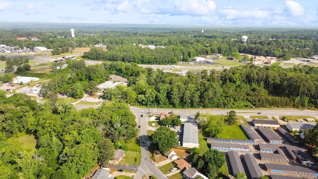 birds eye view of property featuring a view of trees