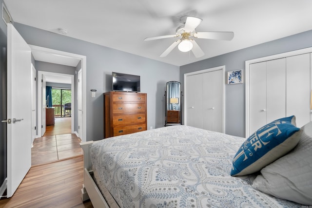 350 Peters Pt Unit L1, Hot Springs, AR 71913 - bedroom featuring two closets, a ceiling fan, baseboards, and wood finished floors