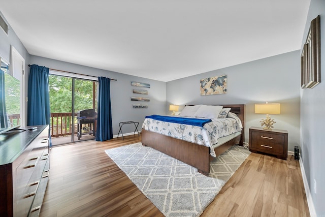 350 Peters Pt Unit L1, Hot Springs, AR 71913 - bedroom featuring access to outside, baseboards, and wood finished floors