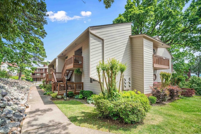 350 Peters Pt Unit L1, Hot Springs, AR 71913 - view of property exterior featuring a lawn, stairs, and a balcony