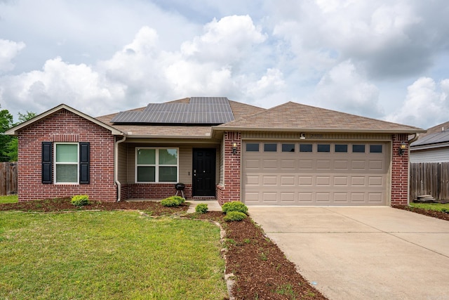 ranch-style home with fence, a front yard, roof with shingles, brick siding, and driveway