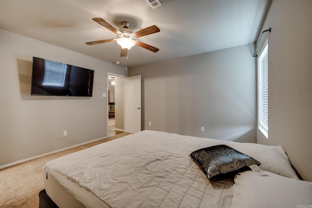 carpeted bedroom with a ceiling fan, baseboards, and visible vents