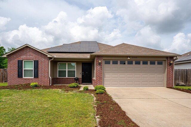 ranch-style house with fence, a front yard, brick siding, concrete driveway, and an attached garage