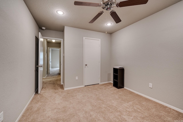 unfurnished bedroom featuring light colored carpet, recessed lighting, baseboards, and ceiling fan