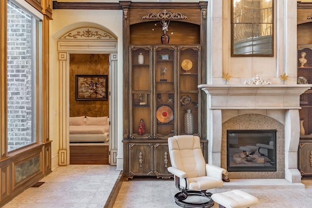 sitting room featuring a tiled fireplace and visible vents