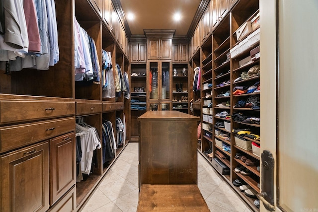 walk in closet with light tile patterned floors