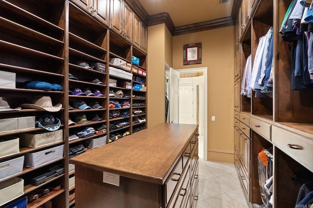 spacious closet with light tile patterned floors