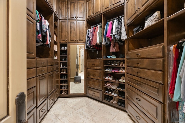 spacious closet with light tile patterned floors