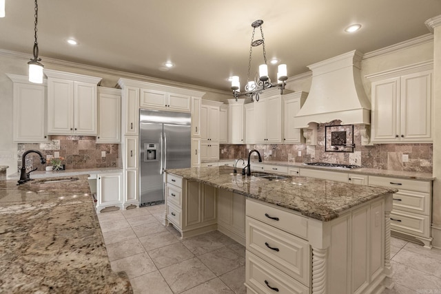 kitchen featuring a sink, decorative backsplash, custom exhaust hood, and stainless steel appliances