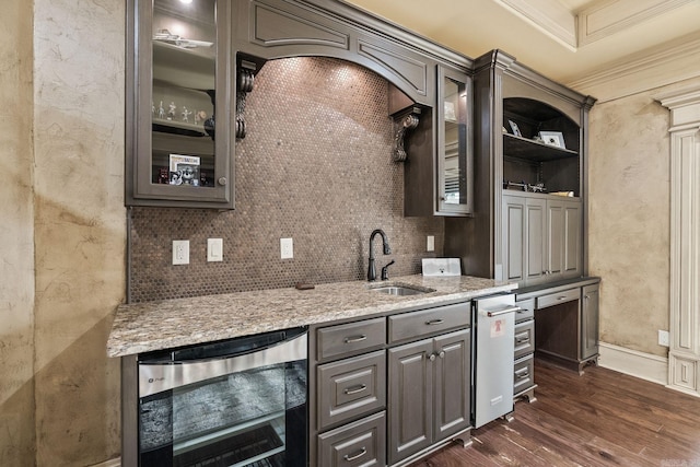 bar with a sink, dark wood-style floors, wine cooler, ornamental molding, and a textured wall