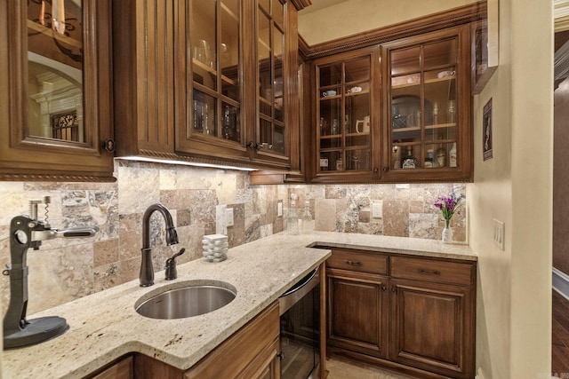 bar featuring beverage cooler, a sink, and tasteful backsplash