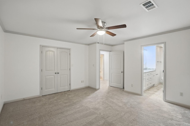 unfurnished bedroom with light colored carpet, baseboards, visible vents, and ornamental molding