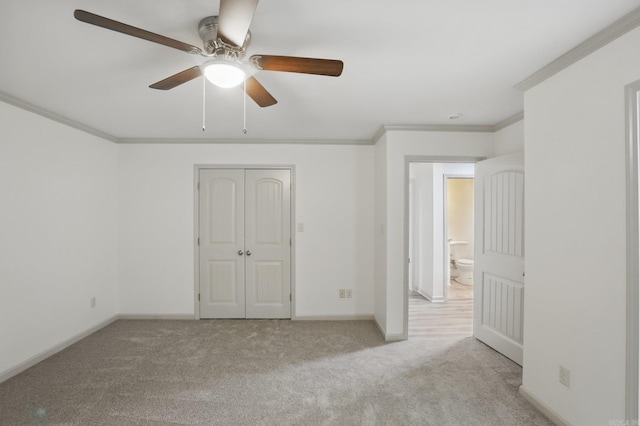 unfurnished bedroom with baseboards, ornamental molding, carpet, and ceiling fan