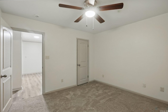 unfurnished bedroom featuring baseboards, ceiling fan, and carpet