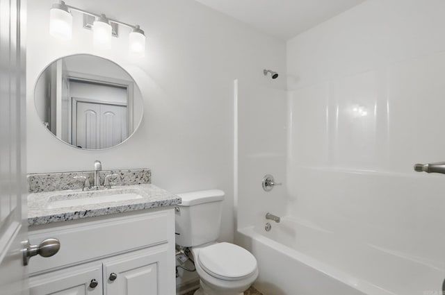 bathroom featuring vanity, bathtub / shower combination, and toilet