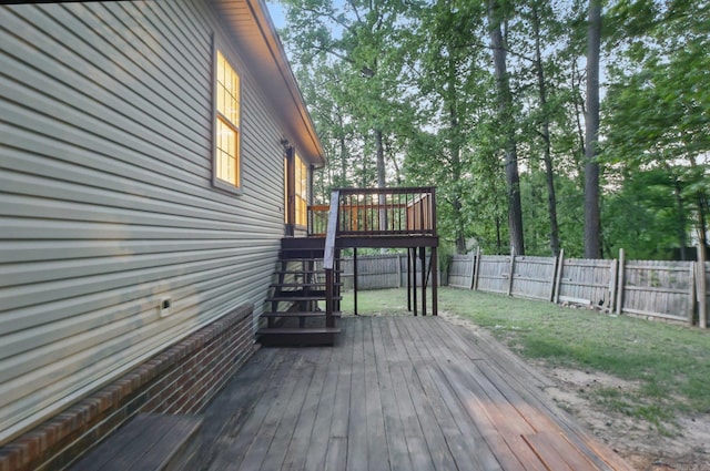deck featuring a yard, stairs, and a fenced backyard