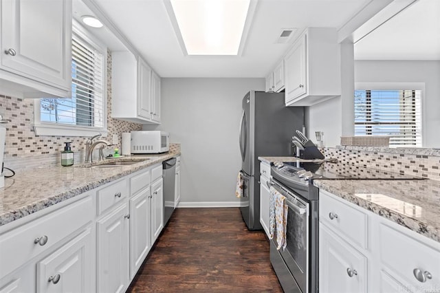 120 Catalina Cir Unit 2A, Hot Springs, AR 71913 - kitchen with a sink, stainless steel appliances, white cabinetry, decorative backsplash, and dark wood-type flooring