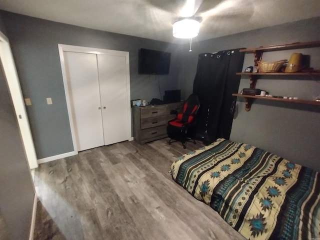bedroom with a closet and wood finished floors