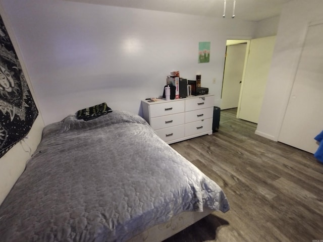 bedroom featuring ceiling fan and dark wood finished floors