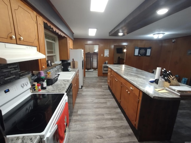 kitchen with a kitchen island, white appliances, light countertops, a sink, and exhaust hood