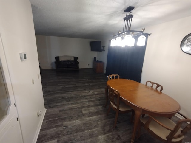 dining room featuring baseboards and dark wood finished floors