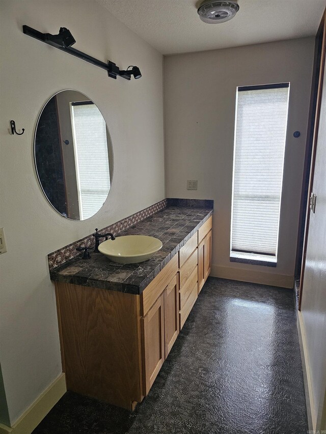 161 Funderburg Rd, Mineral Sprs, AR 71851 - bathroom featuring vanity, baseboards, and concrete floors