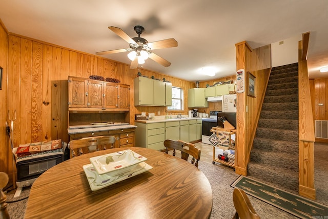 143 Hurricane Dr, Greers Ferry, AR 72067 - dining area with wooden walls, a ceiling fan, stairs, and visible vents