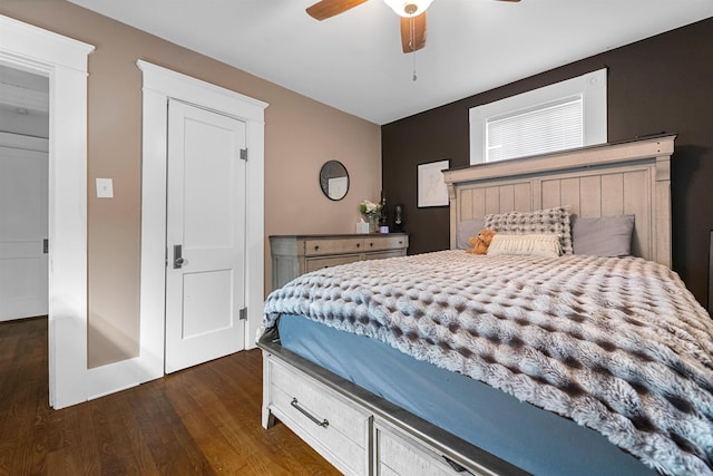 bedroom featuring a ceiling fan and dark wood-style flooring