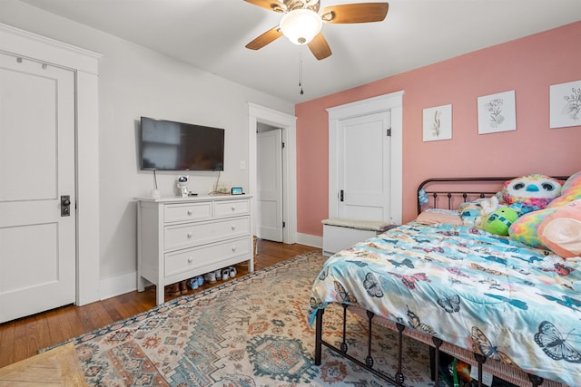 bedroom with baseboards, a ceiling fan, and hardwood / wood-style floors