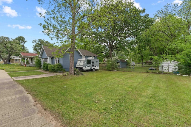 view of home's exterior featuring a storage unit, an outbuilding, fence, and a yard