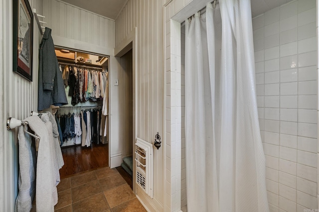 bathroom with curtained shower and a spacious closet