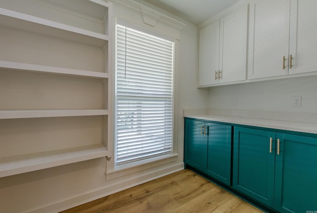 kitchen with open shelves, light countertops, baseboards, light wood-style floors, and green cabinetry
