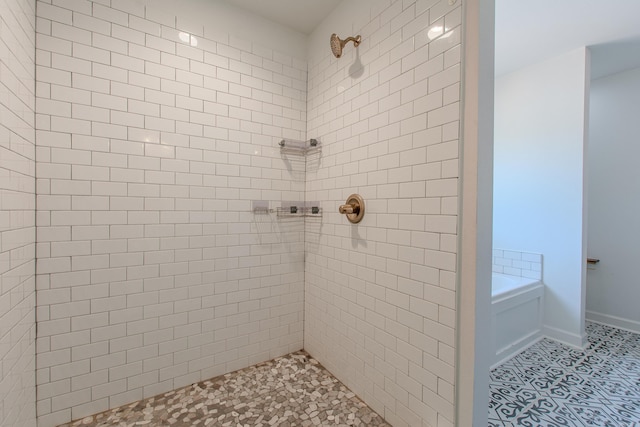 full bathroom featuring tile patterned floors, a bath, and tiled shower