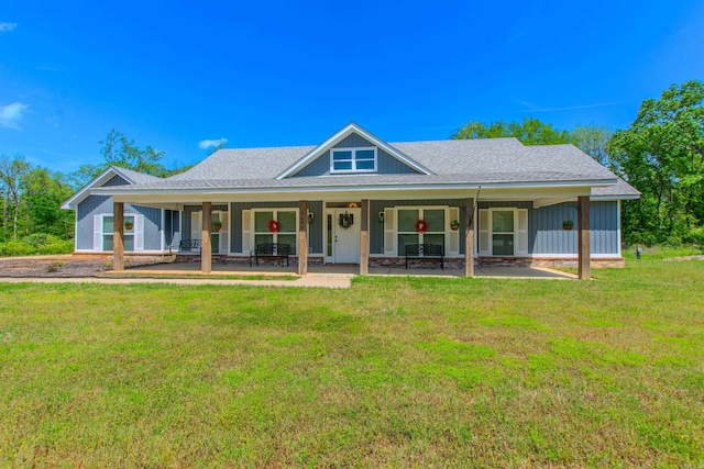 farmhouse inspired home featuring roof with shingles and a front yard