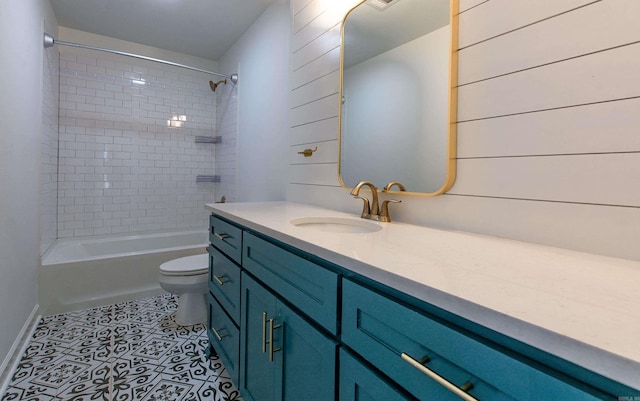 bathroom featuring toilet, baseboards, shower / bathing tub combination, and vanity