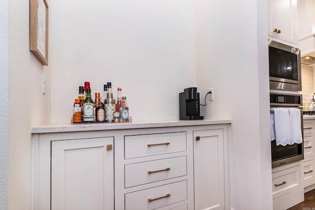 bar with a dry bar and stainless steel appliances