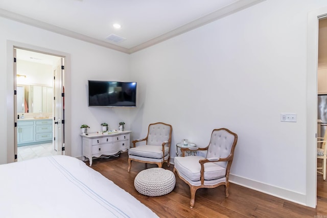 bedroom featuring baseboards, visible vents, ornamental molding, and wood finished floors