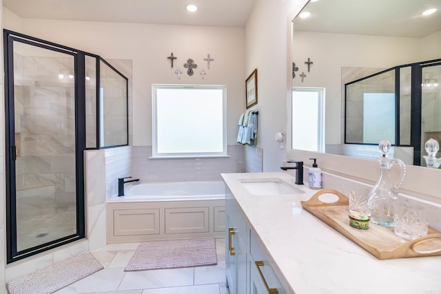 bathroom with recessed lighting, a shower stall, a bath, and vanity