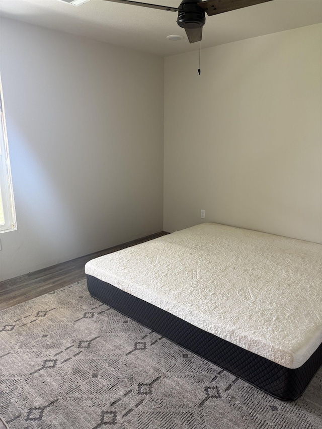 bedroom featuring a ceiling fan and wood finished floors