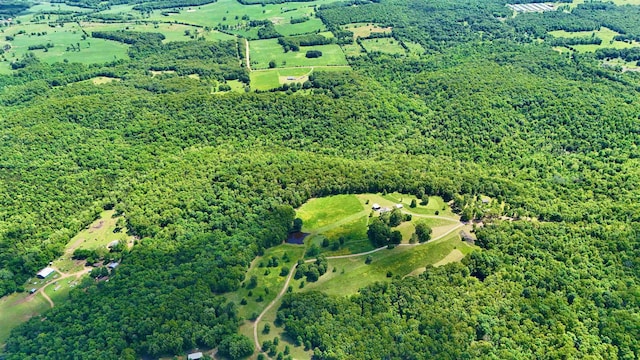 birds eye view of property with a forest view