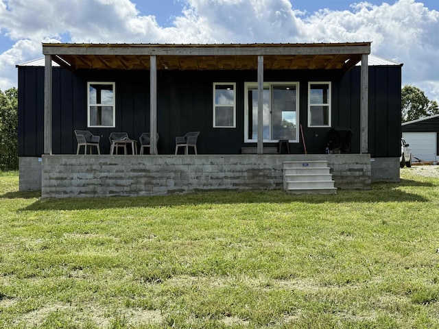view of front of property featuring board and batten siding and a front yard