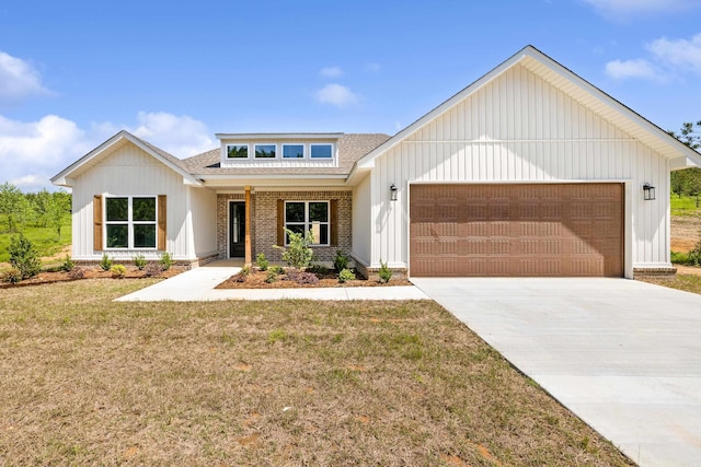 view of front of home with board and batten siding, driveway, a front yard, an attached garage, and a shingled roof
