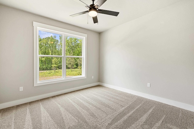 spare room featuring carpet floors, baseboards, and ceiling fan