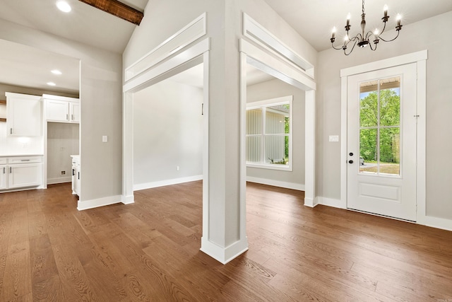 foyer featuring recessed lighting, baseboards, a notable chandelier, and wood finished floors