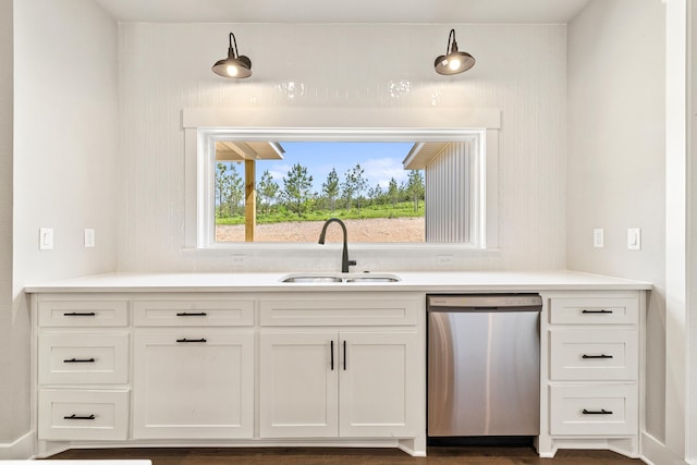 kitchen featuring a sink, light countertops, white cabinets, and dishwasher