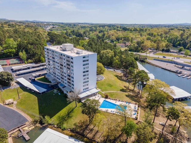 drone / aerial view with a water view and a wooded view