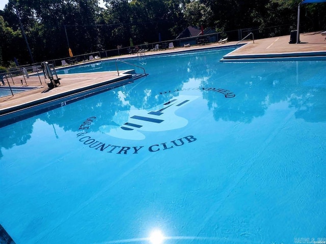 community pool featuring fence