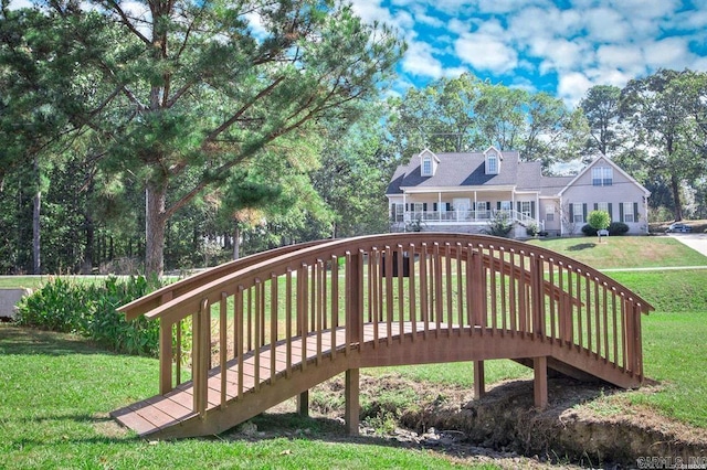 surrounding community with stairs and a yard